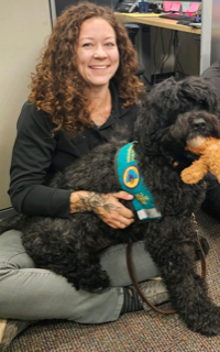 A lady with Arlo holding teddy bear